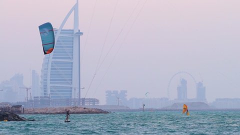 Dubai , United Arab Emirates - 03 09 2021: Extreme Sports Of Kite Surfing On Kite Beach With Misty Burj Al Arab At Background In Dubai City, United Arab Emirates. - Static Shot