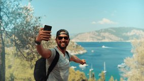 Man Using Mobile Phone For Selfie Photo. Selfie On Smartphone In Beautiful Place. Attractive Tanned Tourist Man Using Mobile App Selfie Photo Video. Guy Taking Picture Vacation Holiday Mediterranean 