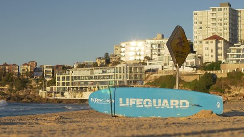 SYDNEY, NSW, AUSTRALIA, JUNE 11 2021. Lifeguard surfboard at Bondi beach on sunny day, slow motion.