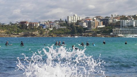 SYDNEY, NSW, AUSTRALIA, JUNE 11 2021. Splash, Bondi beach surf group, slow motion.