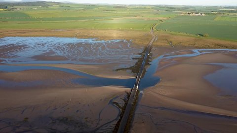 4k drone footage of the causeway to Holy Island of Lindisfarne, Northumberland, UK