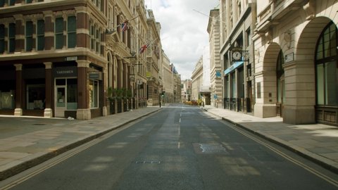 London , England , United Kingdom (UK) - 06 01 2020: Empty City of London streets with closed retail shops in the midday sun, during the Coronavirus lockdown pandemic 2020.