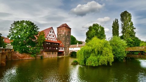 Nuremberg, Franconia, Bavaria, Germany. Timelapse with Nuremberg city houses on riverside of Pegnitz, from Maxbrucke bridge.