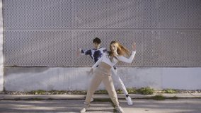Stock video of cool girl and her friend doing dance moves and having fun.