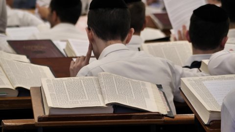 Bnei Brak , Israel - 10 10 2020: A student of yeshiva Jewish religious school explaining text to his friend