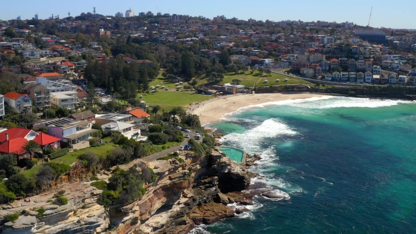 Rugged Coastal Cliffside With Bronte Baths In Bronte Beach, Sydney, New South Wales, Australia. - Aerial Drone Shot 
