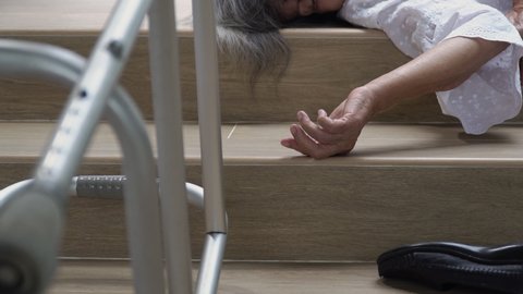 Elderly woman with walker falling down stair
