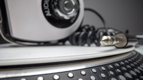 Close up view of a record player with headphones rotating