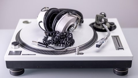 DJ turntables with changing headphones and different coloured record vinyls