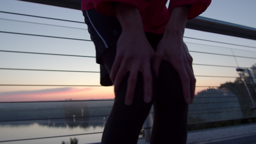 Close up of male knees warming up before running early in the morning on sunrise. Sunrise sport training warm-up.