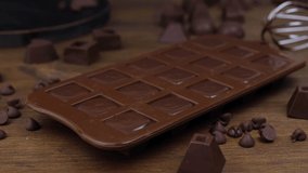Making homemade dark chocolates on wooden background.