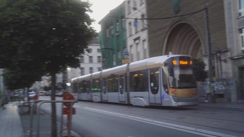 Tram in the centre of Brussels, Belgium going sideways in the street towards the city centre on a warm summer day during the covid-19 pandemic.
