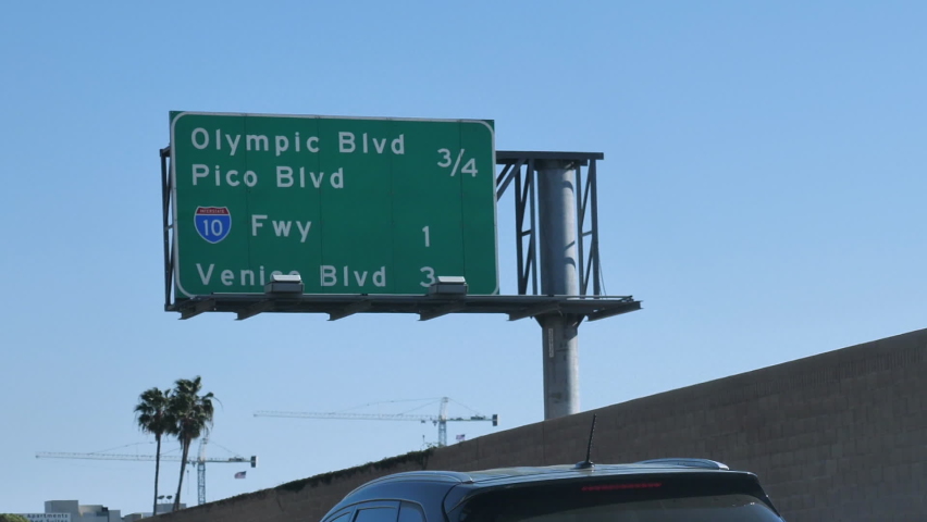 Olympic and Pico Boulevard Highway Exits Sign on Highway 405, Los Angeles, California USA, Driver POV, Slow Motio Royalty-Free Stock Footage #1074350522