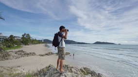 4K Professional man setting Mirrorless Camera taking picture Landscape nature view at Patong beach Phuket Thailand,Landmark famous tourist destination at Phuket
