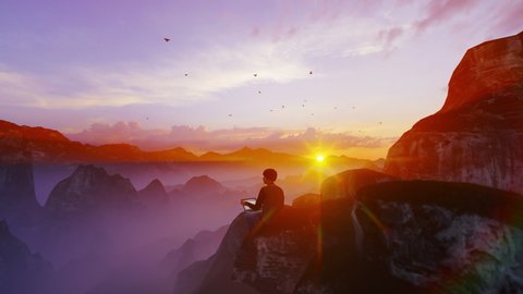 Casual young man with laptop sitting on a cliff above mountain range against sunset, 4K