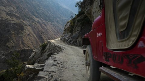 Gilgit-Baltistan , Pakistan - 11 10 2020: Red 4x4 Jeep Driving On Steep Mountain Tracks Of Fairy Meadows Road