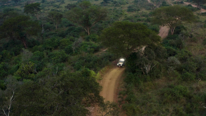 Off road ambulance drives down dirt road in Africa searching for poachers Royalty-Free Stock Footage #1074366008