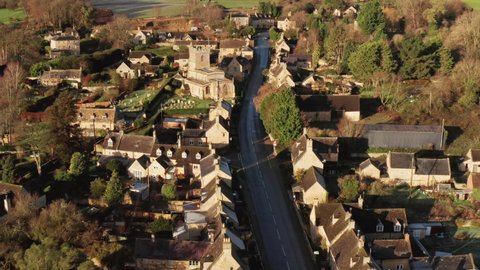 Aerial drone video of a Cotswolds Village, a rural scene in English countryside with houses, property and real estate in the UK housing market, Bourton on the Hill, Gloucestershire, England