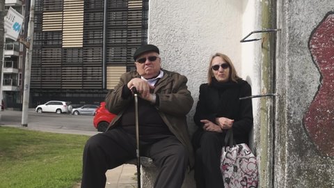 Montevideo , Uruguay - 08 22 2019: Portrait of senior couple in Montevideo streets, Uruguay. Gimbal shot.