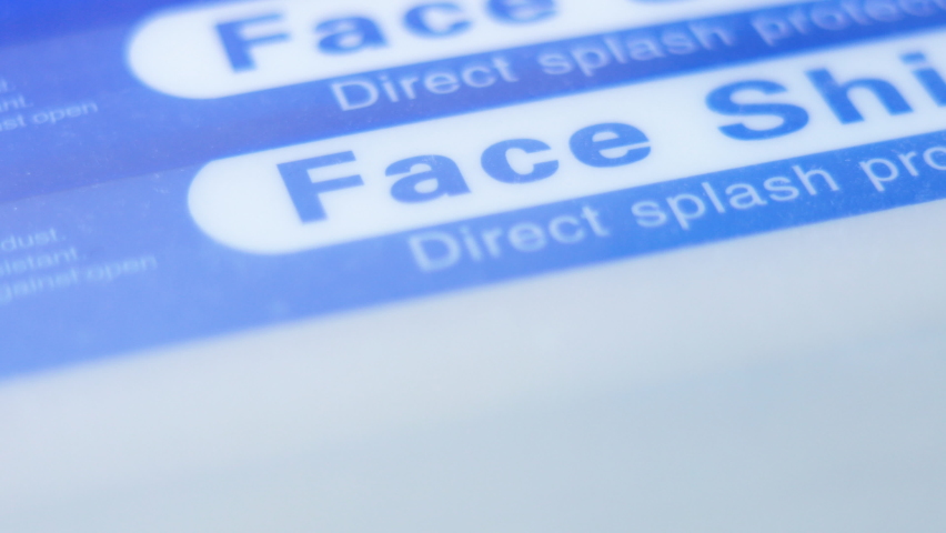 Closeup pan of blue stack of face shields | Shutterstock HD Video #1074367382
