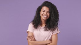Smiling fun young african american woman with curly hair 20s years old wears pink shirt posing looking camera isolated on pastel violet purple color background studio portrait People lifestyle concept - Powered by Shutterstock - Get 15% off with code: PIKWIZARD15