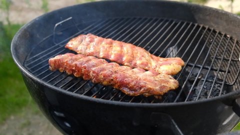 delicious pork ribs  on the BBQ grill. Cook pork meat on grilled meat. Food cooked with grilling barbecue in backyard of house