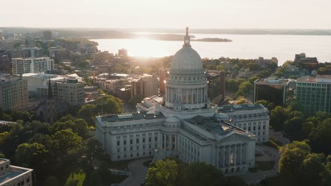 Aerial panorama of Madison city downtown and capitol building. Sunset light at background	