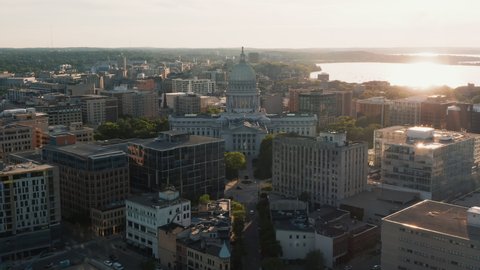 Aerial above street leading to city downtown of Madison with sunset above Lake Mendota, Wisconsin