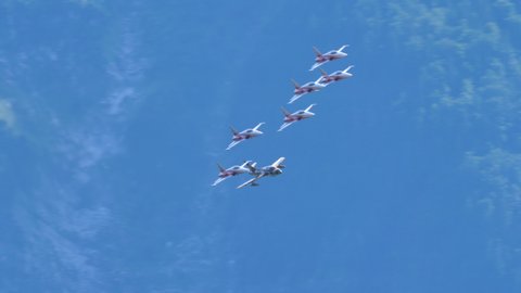 Mollis Switzerland AUGUST, 16, 2019 Fast military combat aircraft formation low pass in a mountain valley Hawker Hunter of Swiss Air Force in Tiger color scheme in formation wit Patroulle Suisse