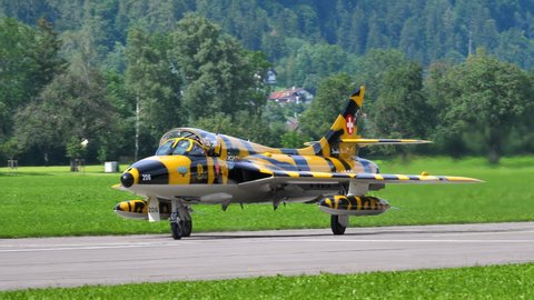 Mollis Switzerland AUGUST, 16, 2019 Close-up view of the cockpit of a cold war military fighter jet taxiing on the runway. Hawker Hunter trainer airplane of Swiss Air Force in Tiger color scheme