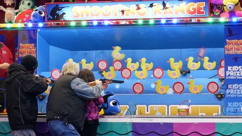 COQUITLAM , British Columbia , Canada - 04 09 2017: Coquitlam, BC, Canada - April 09, 2017 : The motion of people playing shooting carnival game in Coquitlam BC Canada with 4k resolution