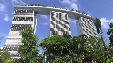 Singapore , Singapore - 03 05 2019: Green Trees In Front Of Marina Bay Sands Hotel In Singapore. Low Angle, Locked Off 