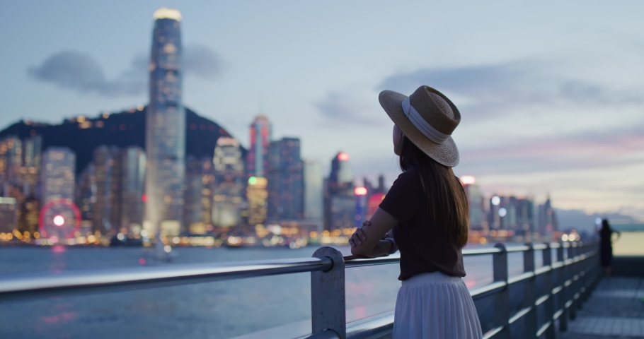 Woman enjoy the view of Hong Kong at sunset Royalty-Free Stock Footage #1074404126