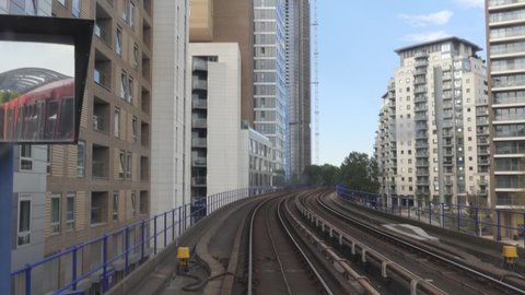 Time lapse. An overground train departing from and arriving at a station.