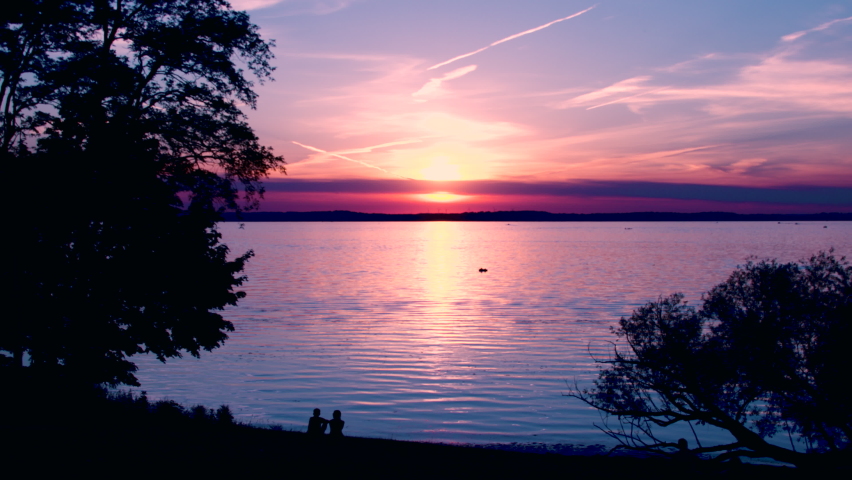 Sunset on a lake with tree silhouettes