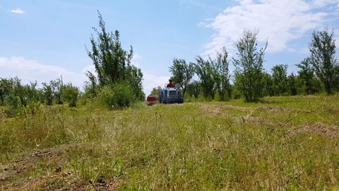 Omurtag , Targovishte , Bulgaria - 06 12 2019: Man Operating Tractor With Hay Tedder In The Meadow 
