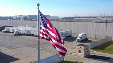 chicago , United States - 12 14 2020: USA flag flying proudly over unlimited carriers company truck parking in Chicago
