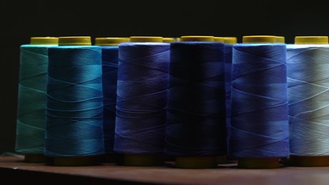 Shot Of Colourful Cotton Thread Spools Inside A Clothing Manufacturing Sweatshop