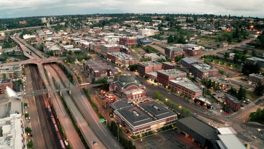 Cinematic 4K aerial drone dolly sunset clip of the downtown commercial and waterfront area of Tacoma, a city near Seattle in Western Washington, Pacific Northwest, the economic center of Pierce County