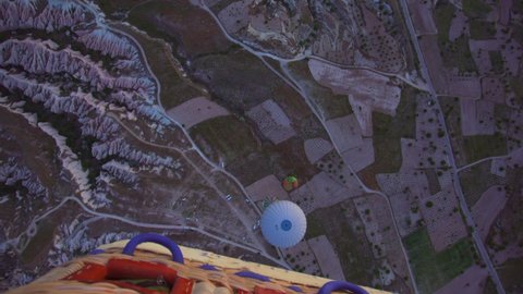 Goreme, Cappadocia, Turkey - May 27, 2021: Ballooning in Kapadokya. Many hot air balloons flying over spectacular breathtaking unusual valleys and rocks in blue sunrise morning sky. View from balloon
