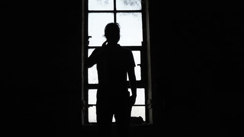 Antwerpen, Antwerpen Belgium 18 06 2021: Man standing silhouetten in window.
