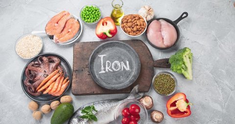 Food high in iron on light gray background. Healthy eating concept. Top view, flat lay. Video footage, stop motion, animation