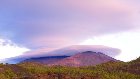 Lenticular cloud above volcanoes Pico Viejo and Teide in Tenerife, 4k Timelapse. The Teide volcano cannot be seen because it is inside the lenticular cloud. They call this phenomenon "The Little Hat"