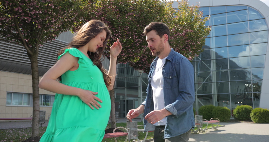 Happy future dad listening the belly of his pregnant wife.