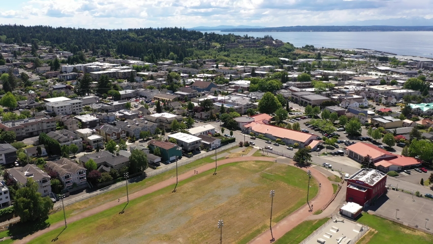 Cinematic 4K drone trucking footage of the downtown Edmonds commercial area, Kingston ferry terminal waterfront marina, near Seattle in Western Washington, Pacific Northwest, in Snohomish County