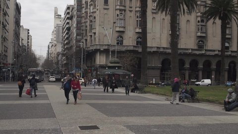Montevideo, Uruguay - 08 22 2019: Slow pan tilt up of Salvo Palace seen from Plaza Independencia, Montevideo.