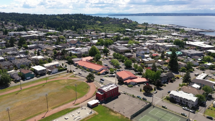 Cinematic 4K drone trucking shot of the downtown Edmonds commercial area, Kingston ferry terminal waterfront marina, near Seattle in Western Washington, Pacific Northwest, in Snohomish County