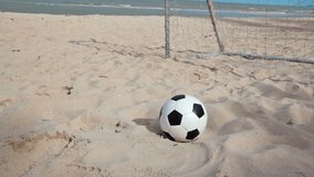 Football and goal on sand beach and blue sky background in HD, dolly tracking camera shot at day light time
