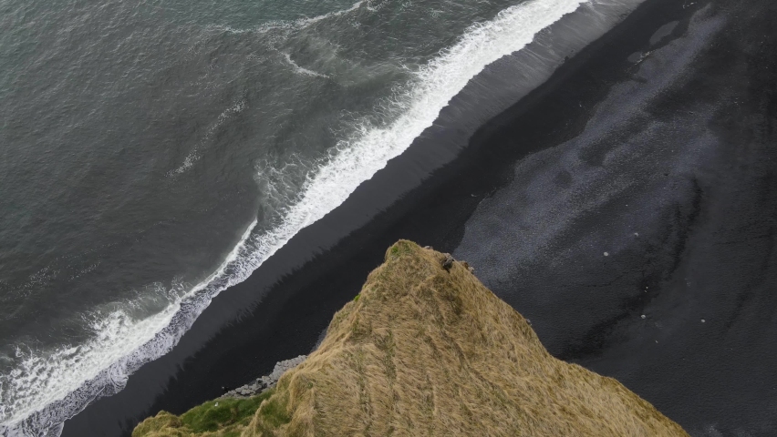 Iceland Reynisfjara Black Sand Beach with Basalt Columns Aerial Drone Royalty-Free Stock Footage #1074450419