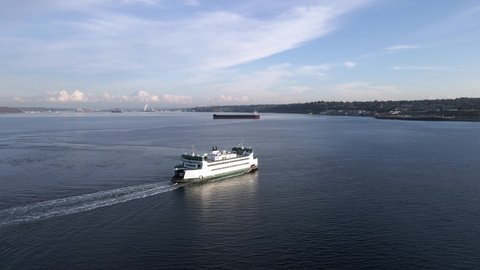 Tacoma , WA , United States - 10 22 2020: Golden sun reflecting off the Vashon Island Ferry, Mount Rainier, Port of Tacoma in the background, aerial